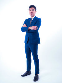 Portrait of young man standing against white background