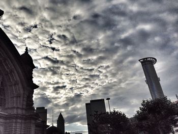 Low angle view of buildings against cloudy sky