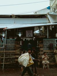 People at market stall in city