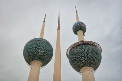 Low angle view of communications tower against building