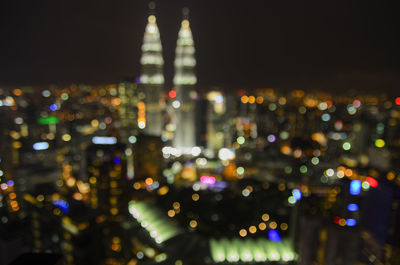 Defocused image of illuminated city at night