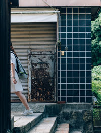 Reflection of woman on window of house