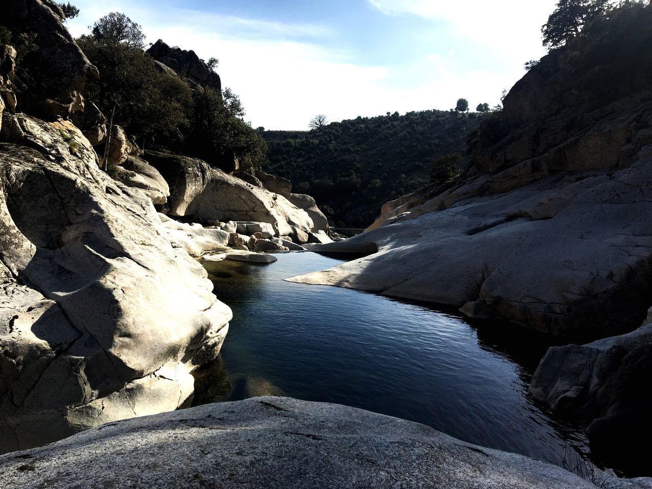 SCENIC VIEW OF ROCKS IN WATER AGAINST SKY