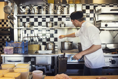 Male chef cooking in kitchen at restaurant