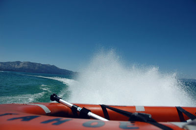 Boat moving on sea against sky