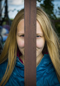 Portrait of young woman face with wooden log