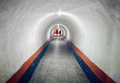Man in illuminated tunnel