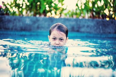 Portrait of boy swimming in pool