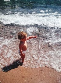 Woman jumping in sea