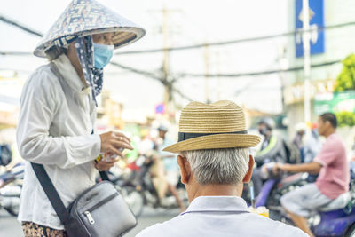 Rear view of people walking on street