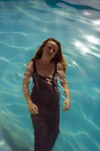 High angle portrait of young woman in swimming pool