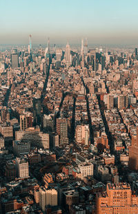 Aerial view of buildings in city against sky