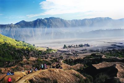 Panoramic view of people on mountain against sky