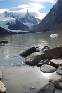 Scenic view of lake and snowcapped mountains against sky