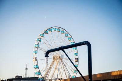 Low angle view of ferris wheel against clear sky