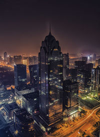 Aerial view of illuminated buildings in city at night