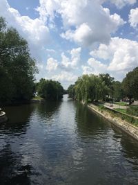 River amidst trees against sky