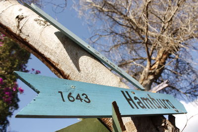 Low angle view of road sign against sky