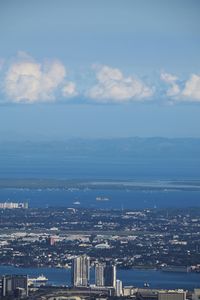 High angle view of buildings by sea against sky