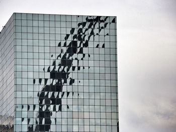 Low angle view of text on building against sky