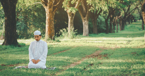 Religious muslim man praying  outdoor at quiet nature  environment sun beams.