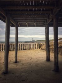 View of pier on beach against sky