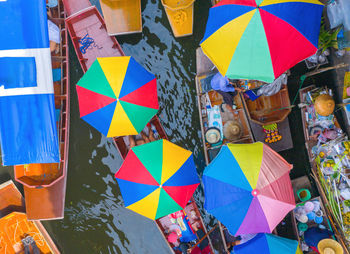 Multi colored umbrellas hanging at market stall