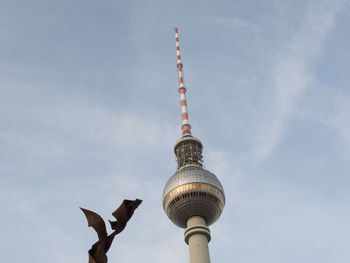 Low angle view of communications tower against sky