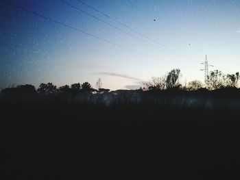 Silhouette trees against sky during sunset