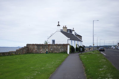 Empty road along built structures
