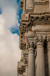 Low angle view of historical building against cloudy sky