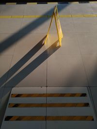 High angle view of yellow flag on tiled floor