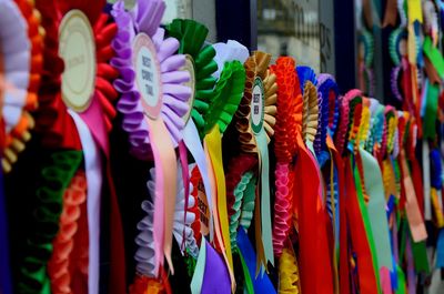 Close-up of multi colored badges for sale in market