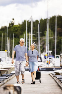 Senior couple walking on pier