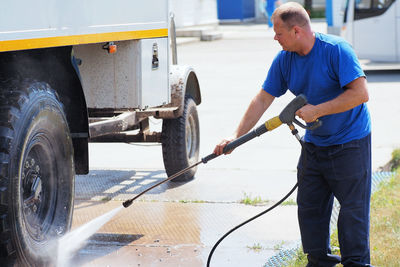 Low section of man cleaning car