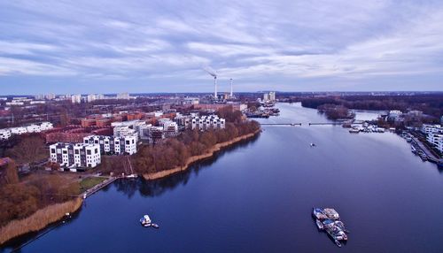 High angle view of river by city against sky