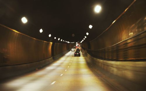 Cars moving on illuminated tunnel