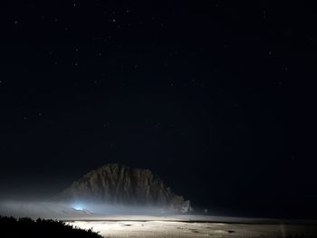 Scenic view of sea against sky at night