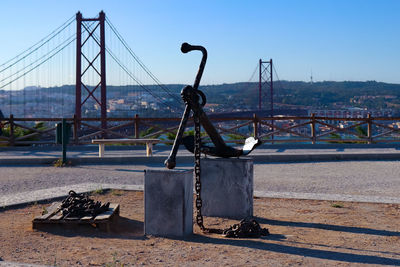 Bridge over river in city against clear sky