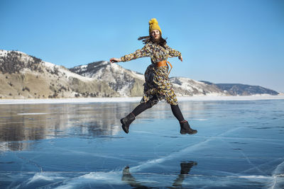 Full length of woman standing on snow