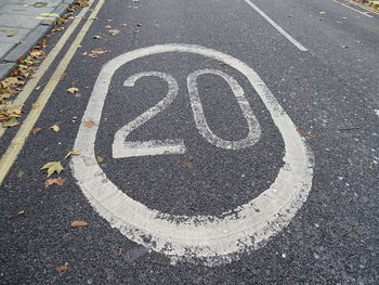 High angle view of arrow symbol on road in city