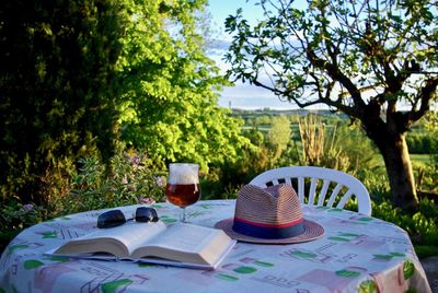 Open book on table against trees