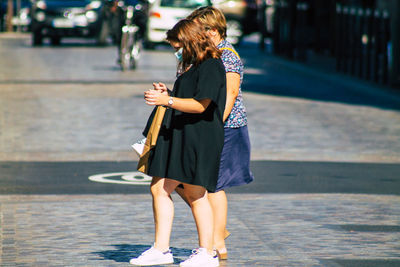 Woman standing on street in city