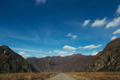 Scenic view of mountains against blue sky