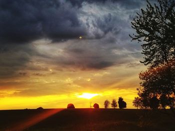 Scenic view of silhouette landscape against orange sky