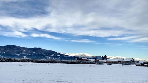 Scenic view of snow covered mountains against sky