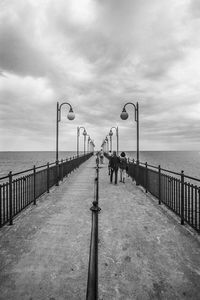 View of pier on sea against sky