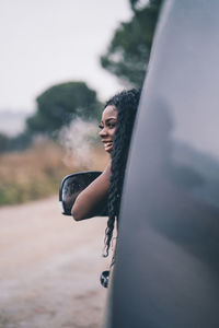 Nice african woman in car window.