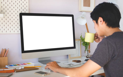 Man using computer on table at home