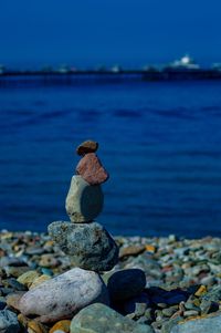 Stones stacked on shore at beach